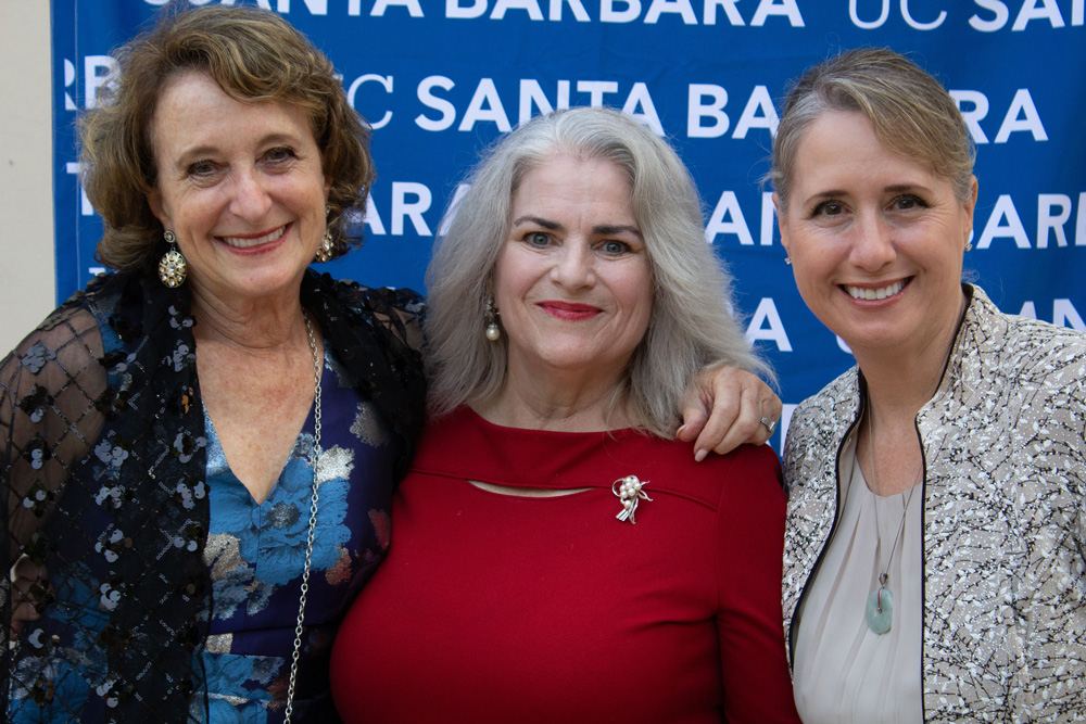 three alumni having their photo taken