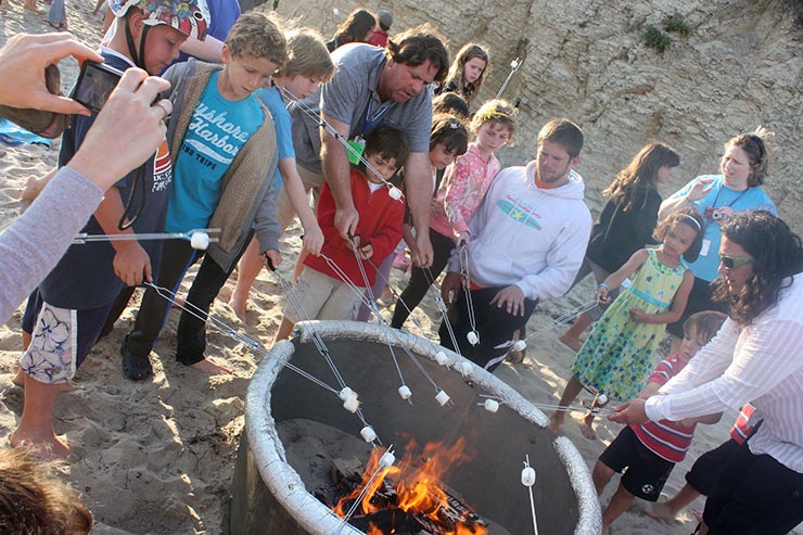 people roasting marsh mellows