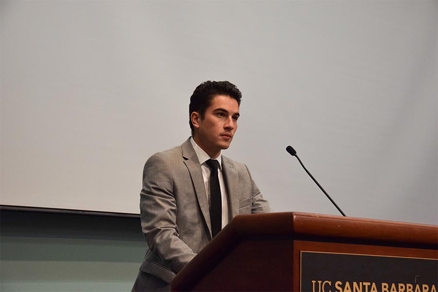 Alperon speaking at a awards dinner